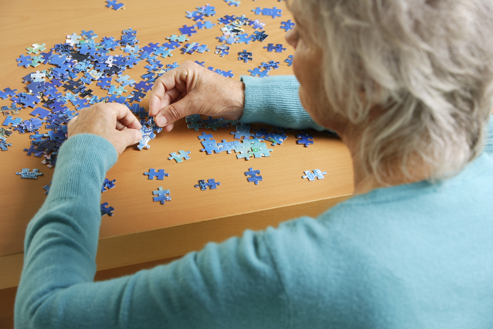 Elderly woman doing a puzzle